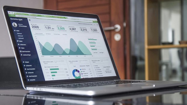 Laptop computer showing a dashboard of charts