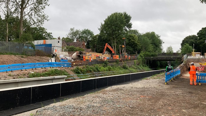 Pineapple Road Station construction site with view of tracks and bridge