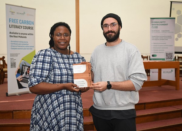 Two people at a wildlife conference. Holding a brochure.