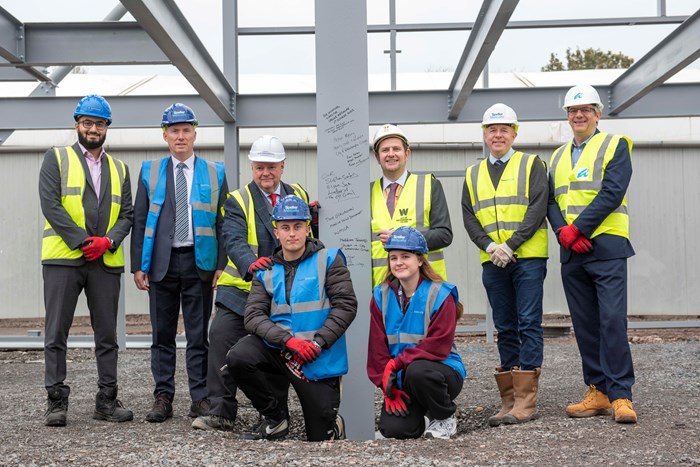 Partners sign the first steels for the construction of the new Advanced Technology and Automotive Centre. L to R (back row) - Ravi Verma, Turner & Townsend Project Manager; Tony O’Callaghan, WMCA Head of Skills Development; Cllr Stephen Simkins, City of Wolverhampton Council Leader; Pete Merry, Deputy Chief Executive at City of Wolverhampton College; Rob Lashford; Speller Metcalfe Director; and Jonathan Astley, Architect at Astley Partnership Ltd. L to R (front row) – City of Wolverhampton College Construction and Built Environment students, Bailey Bridgen, aged 17, and Maddison Jennings, aged 18.