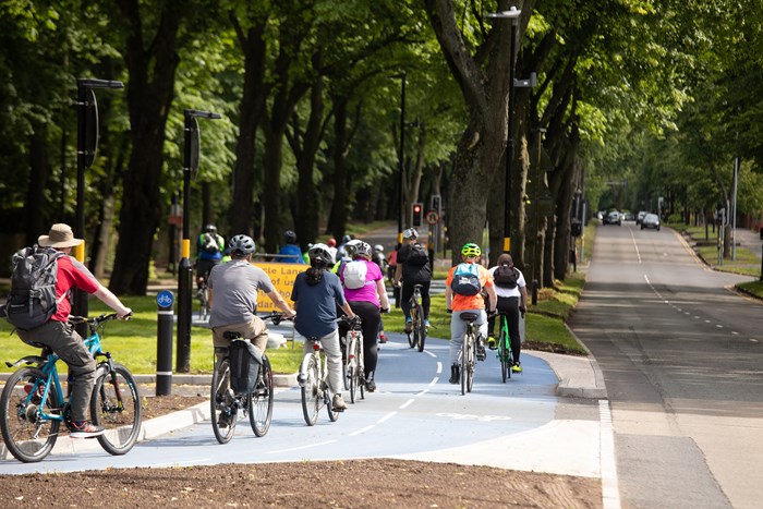 Group riding bikes along A38 cycle route in Birmingham