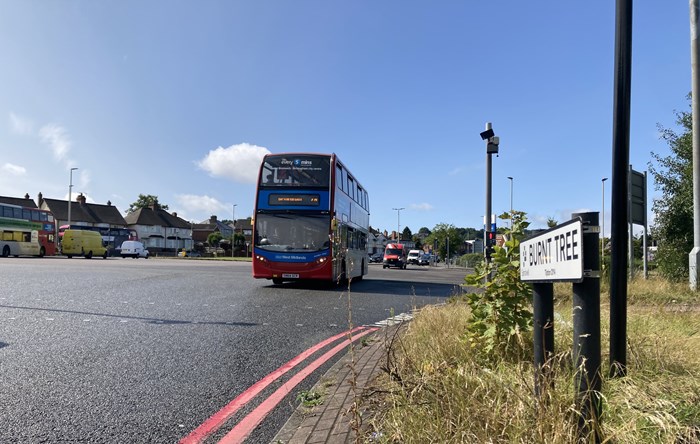 Double decker bus with traffic going through the busy Burnt Tree junction