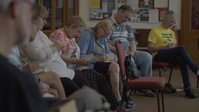 Group of participants at a songwriting creative workshop in Brierley Hill, part of the TfWM series promoting active travel through art.