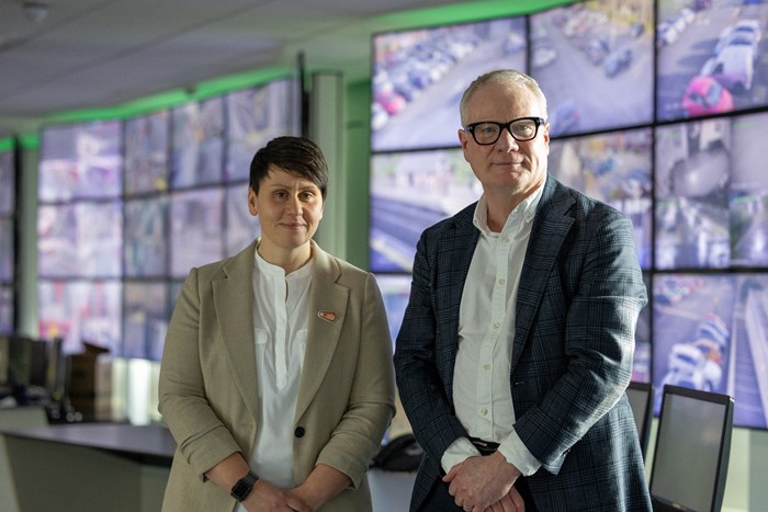 Beccy Marston and Mayor Richard Parker in front of a wall of CCTV screens