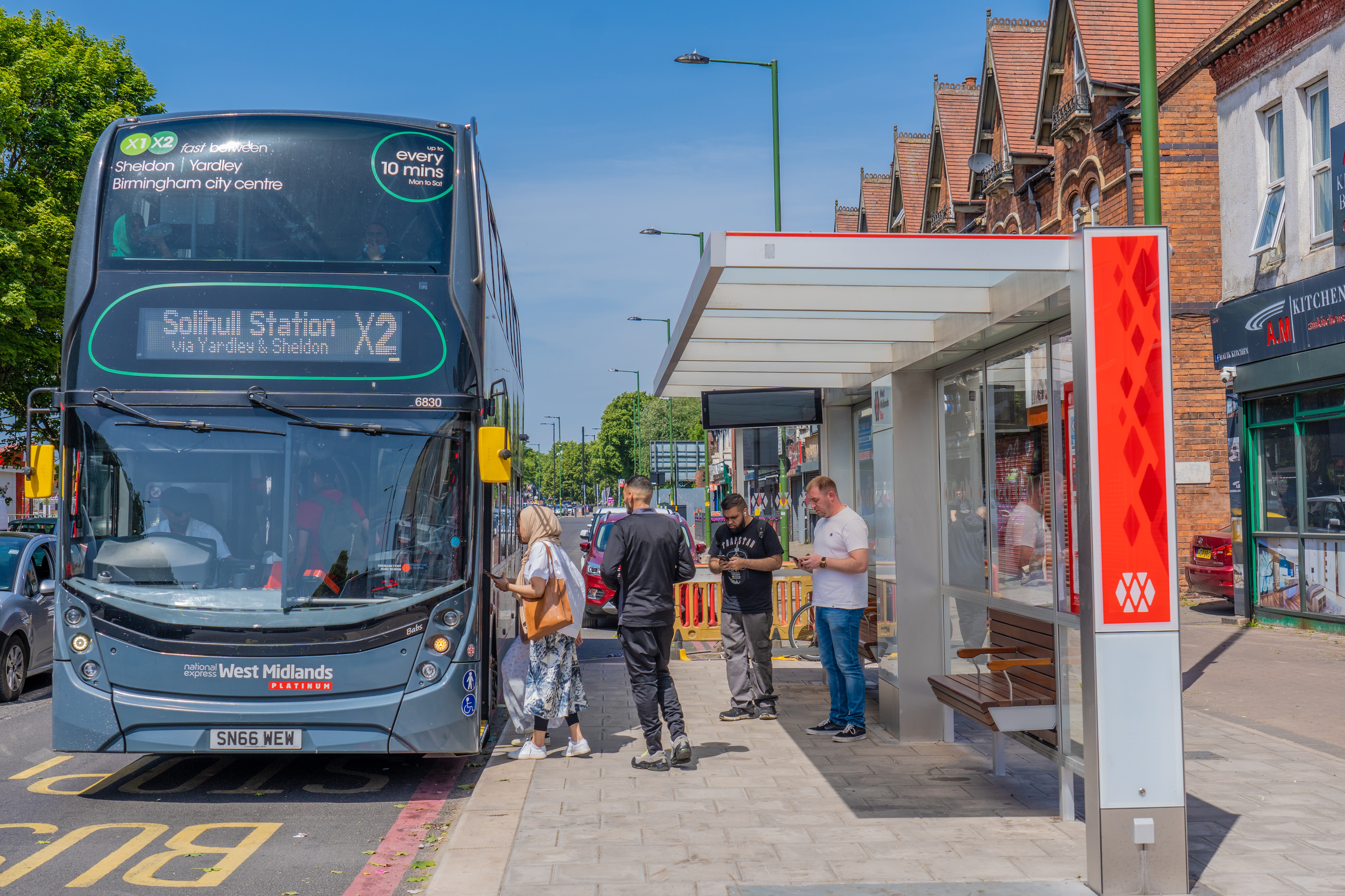 People boarding X2 bus at new Sprint shelter on A45 in Birmingham