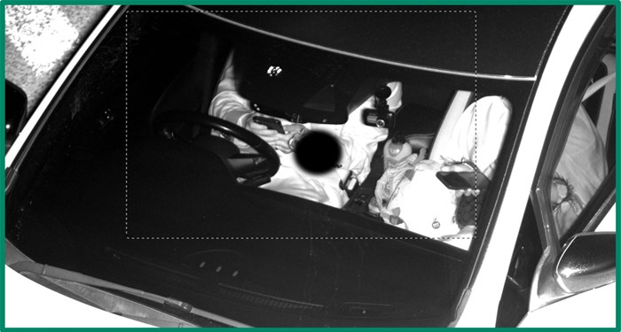 Security camera image shows driver with both hands on phone and not on the steering wheel