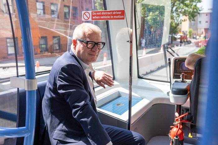 Mayor Richard Parker sitting on the VLR tram as it travels down a Coventry street