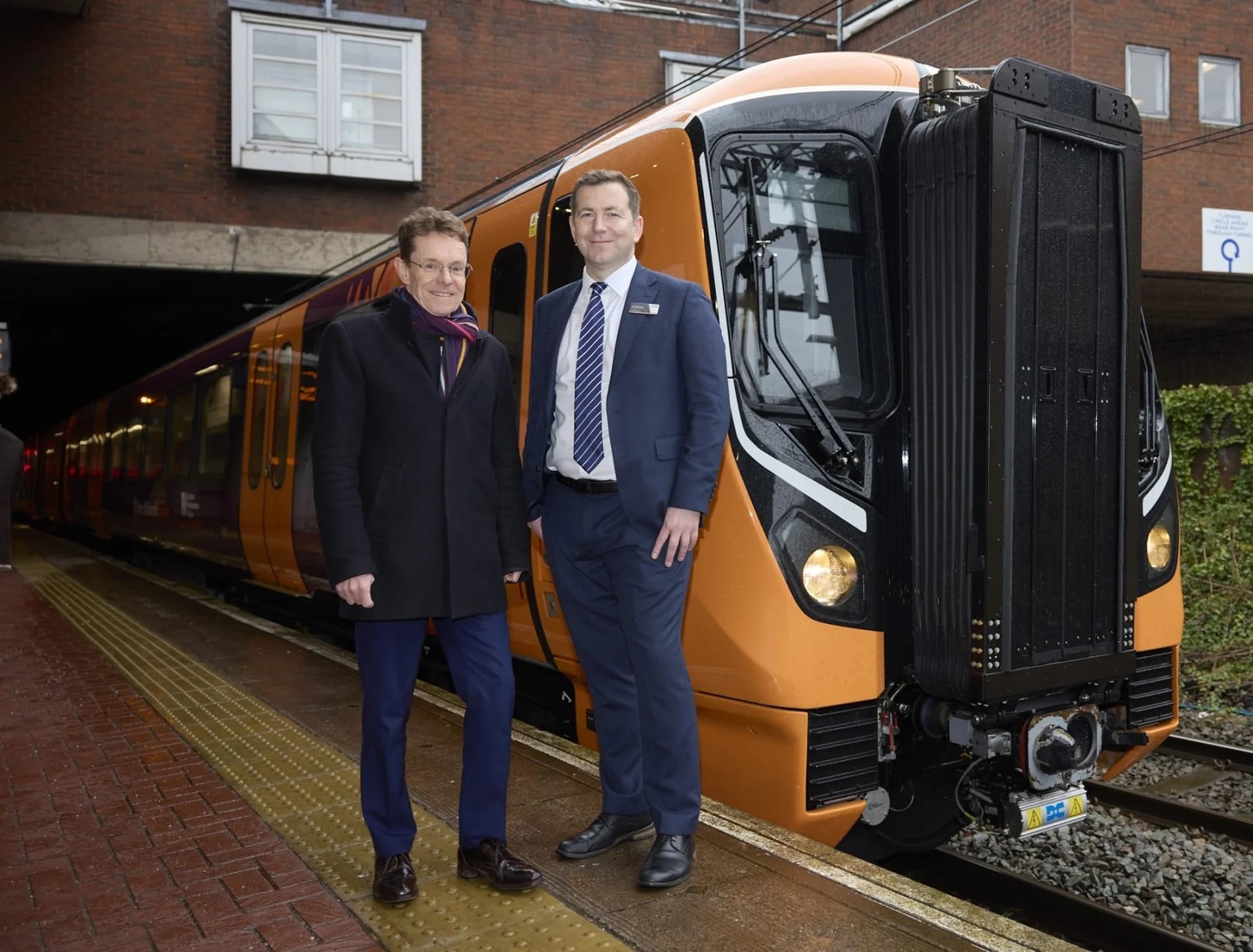 Mayor and West Midlands Railway managing director standing next to one of the new electric trains