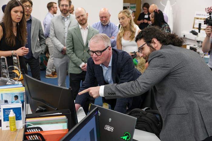 Dr. Magdalena Karlikowska, Cytecom’s CEO (far left) and Phd student Tudor Onose (right) show Mayor Richard Parker the ground breaking technology