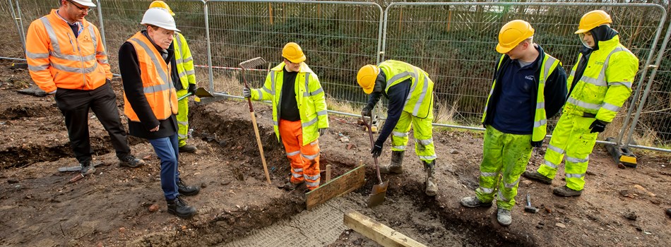 7 construction workers digging into the ground
