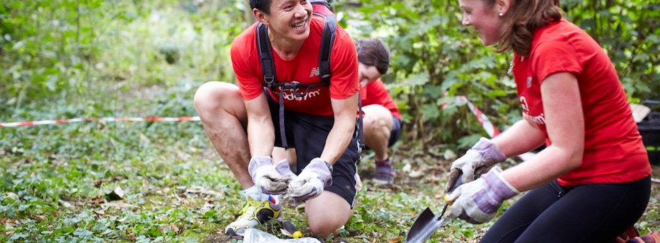 Two people gardening in a woodland