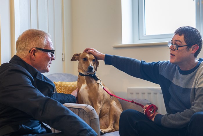 Richard Parker, Mayor of the West Midlands (left), met with social housing tenant David Hopper and his dog Honey at David's new social rent home in Coventry
