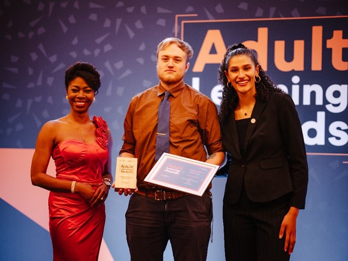 Sam Hutchings (centre) received the accolade for Workplace Learning at the WMCA Adult Learning Awards 2025 held earlier this year, from BBC News presenter, Nicola Beckford (left) and inspirational apprentice Santina Bunting (right) who now works for Arup.