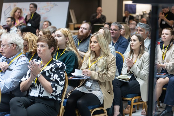 Audience clapping at the conference
