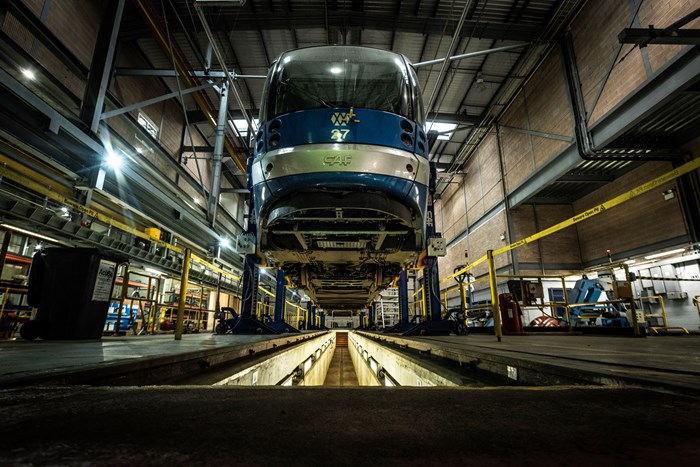 A tram on raised platform in the depot workshop