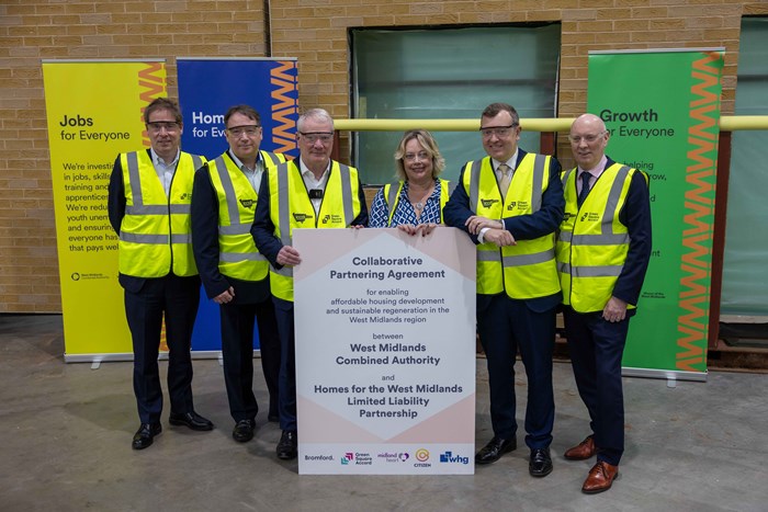 Line up ofsix representatives of the key partner organisations in high-vis yellow vests at t