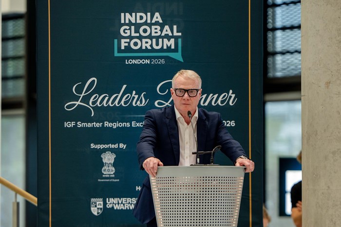 A person in a suit speaks at a podium during the India Global Forum in London 2026. The backdrop reads "Leaders' Dinner." The setting is formal.