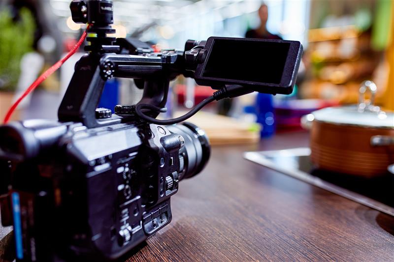 A camera on a desk in a film studio set.