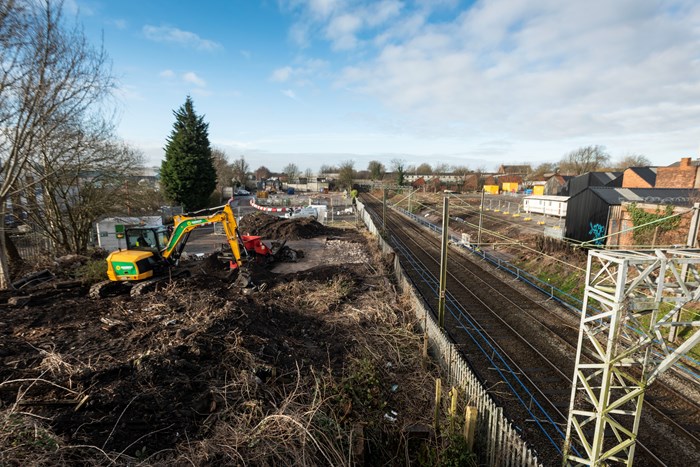Willenhall Station demolition and building site with giant digger and railway track alongside