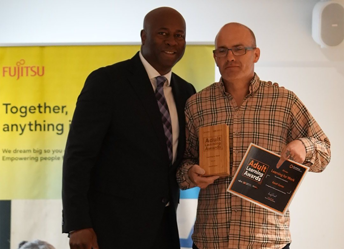 Geoff receives his WMCA Adult Learning Award from former Eastenders actor Nicholas Bailey