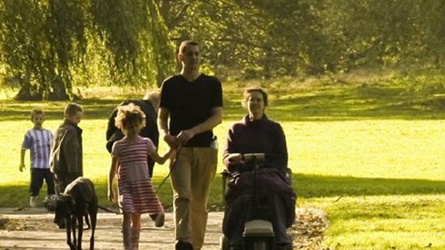 A park with a young family walking on a path