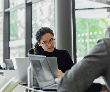 Woman at a laptop in an office space
