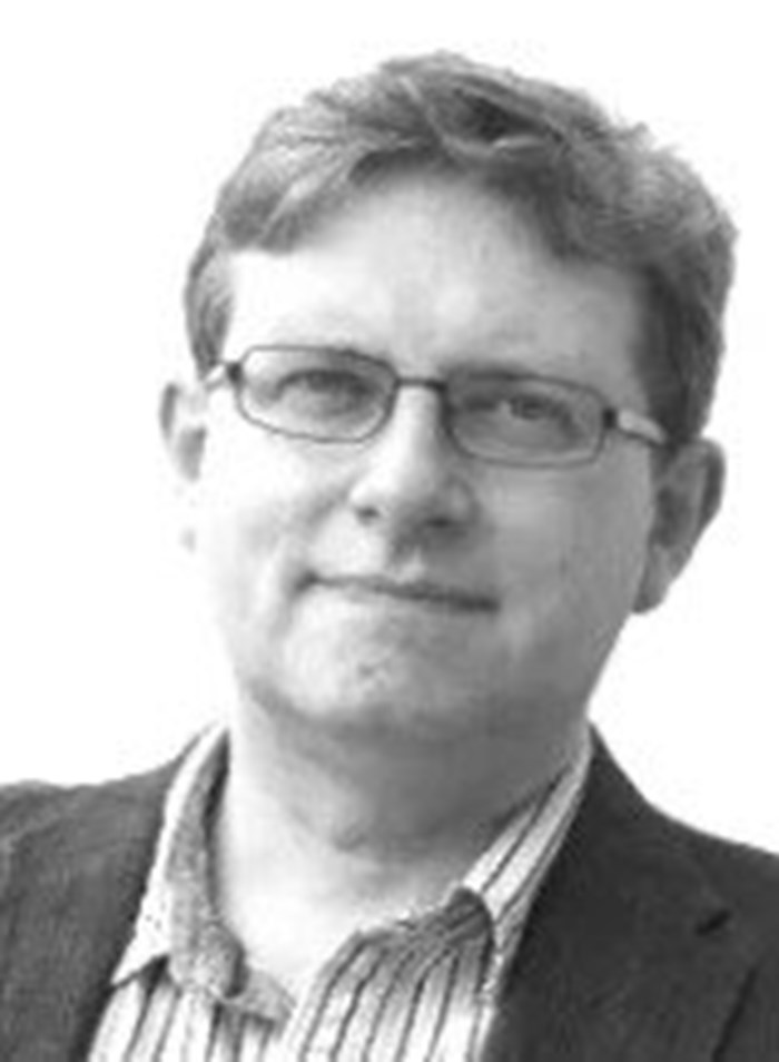 A headshot of a man looking at the camera