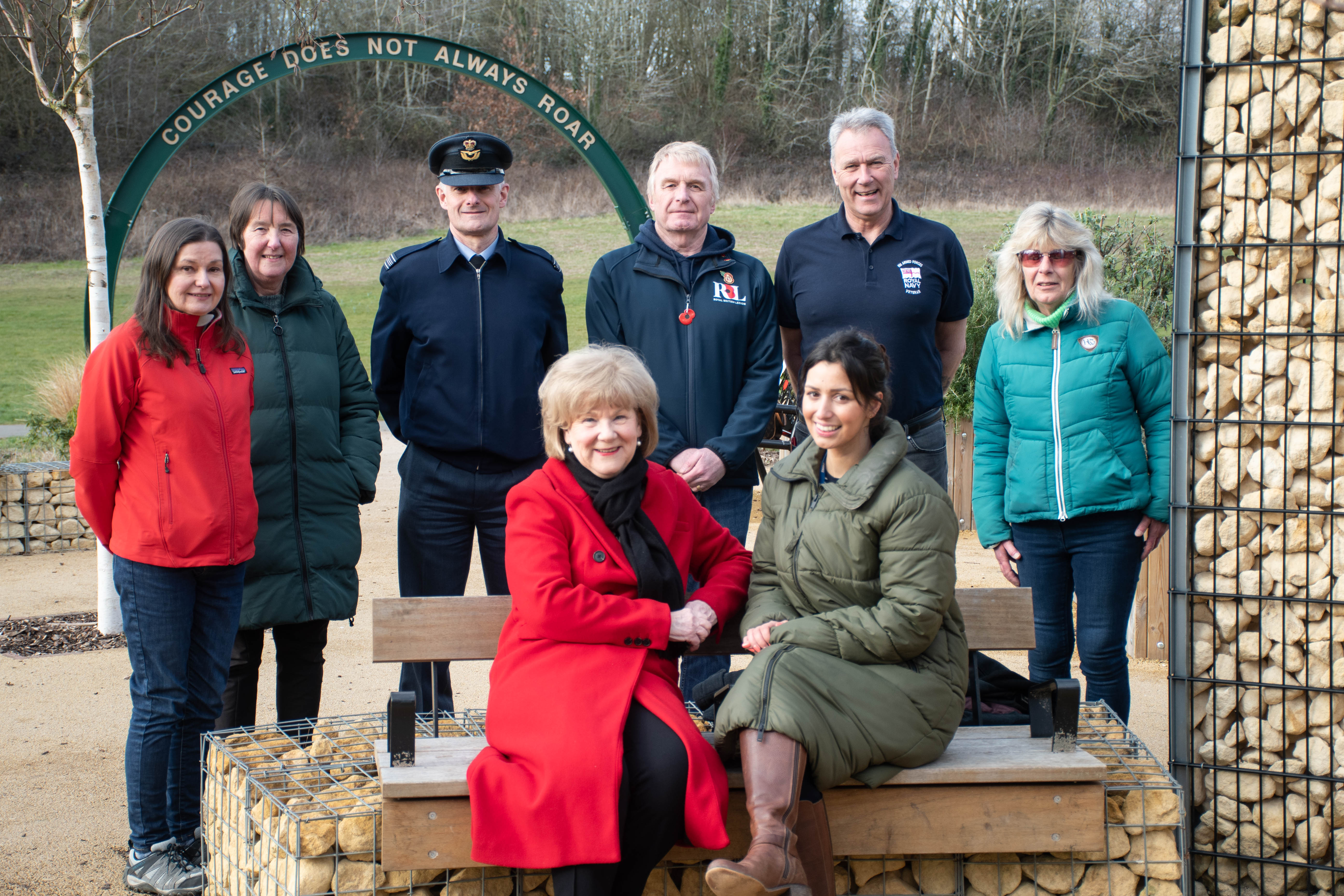 A group of people sitting in the Royal British Legion's Armed Forces Community Garden in Solihull.