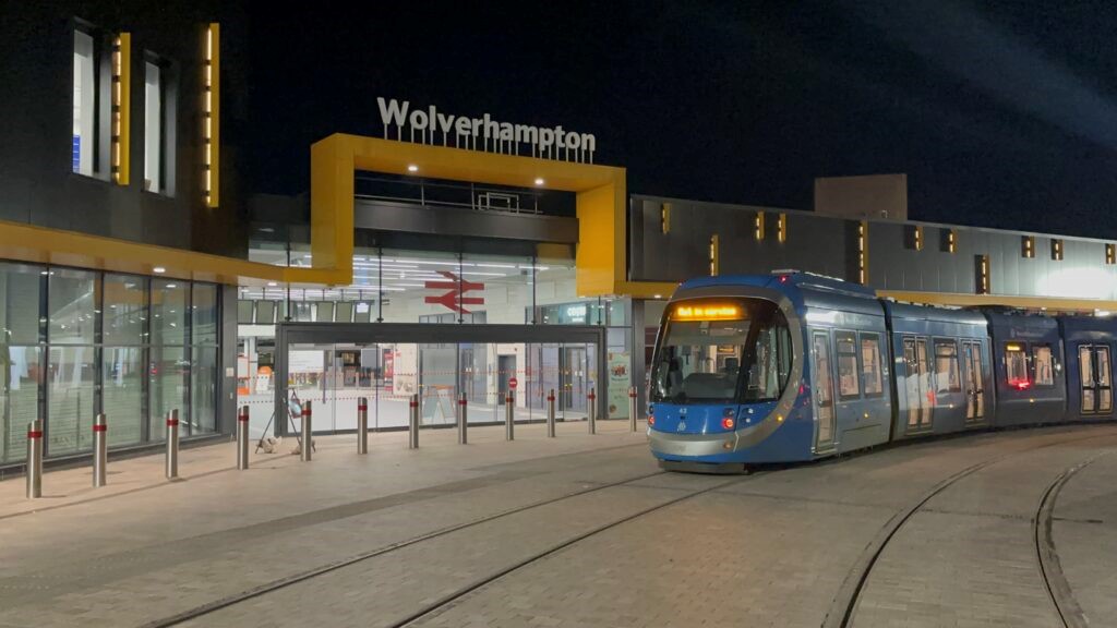 Blue West Midlands Metro tram outside Wolverhampton Railway Station