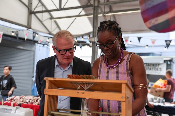 Two people concentrating on a task on a market stall
