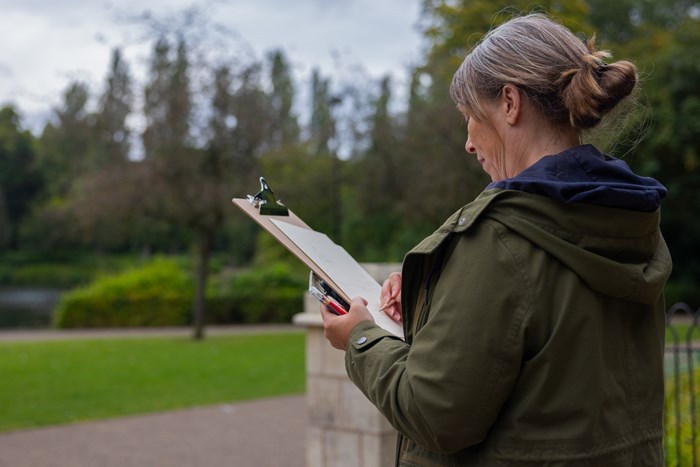 Participant at a "Sketch and Walk" creative workshop in Walsall Arboretum, part of the TfWM series promoting active travel through art.