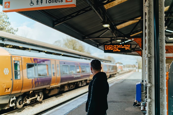 person waiting for train at a railway station