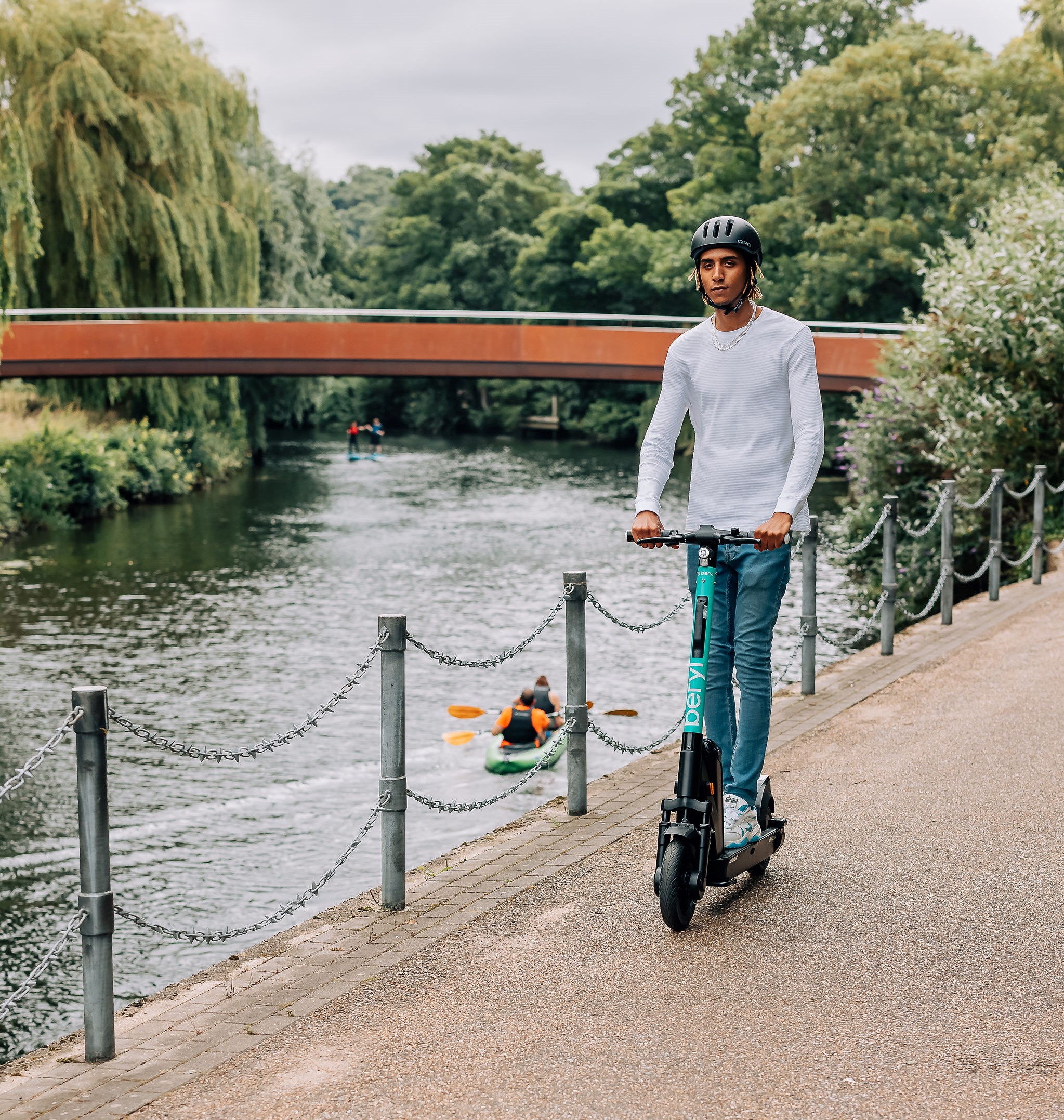 A Beryl e-scooter being ridden alongside a river