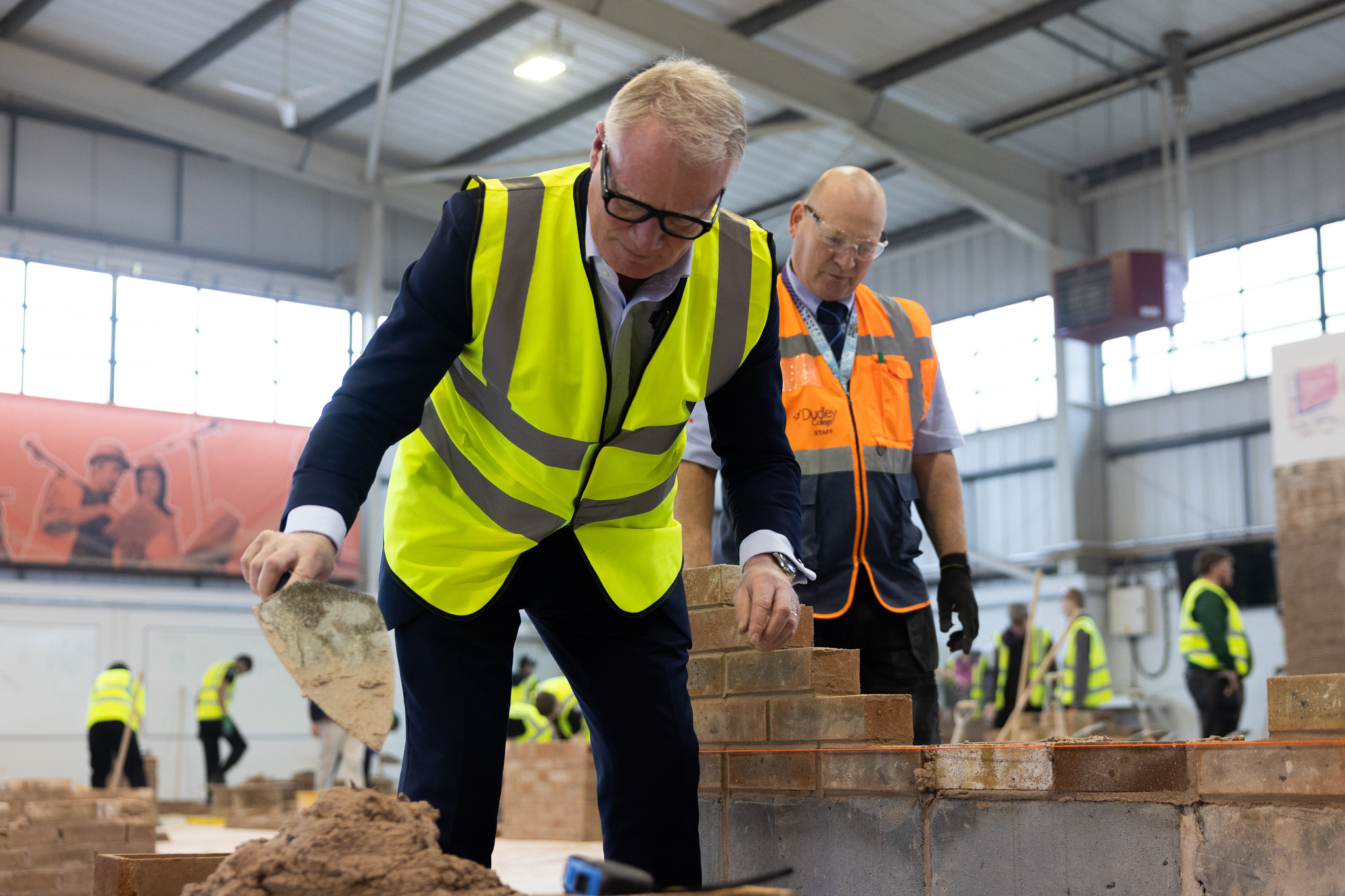 Mayor Richard Parker brick laying at Dudley College training facility with Rob Smith, Curriculum Manager at Dudley College
