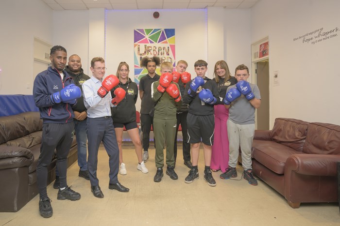 Joshua Jones, community boxing apprentice at England Boxing; Kem Saunders, youth worker at Urban Heard; Andy Street, Mayor of the West Midlands and WMCA chair; Nicky Stevens, operations manager at Urban Heard; Harley Murphy, youth worker; and Charly Slater, founder of Urban Heard with young people who use the youth centre.