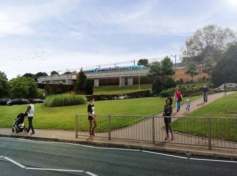 Computer generated image shows a grassed embankment with a large tree to the right and pathway leading up. There are a few people milling about. Along the top of the embankment under a clear blue sky a Metro tram runs along a raised track on a concrete structure