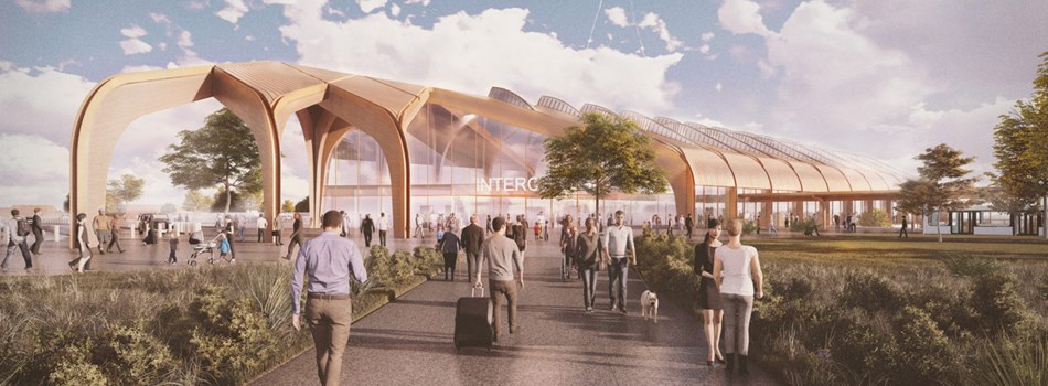 “Computer-generated image of the planned Interchange Station showing a modern building with a glass façade, landscaped public space, trees, and people walking outside.”