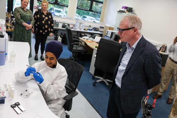 R&D scientist Inderpreet Kaur gives Mayor Richard Parker a demonstration of the diagnostic device - the first of its kind in the world