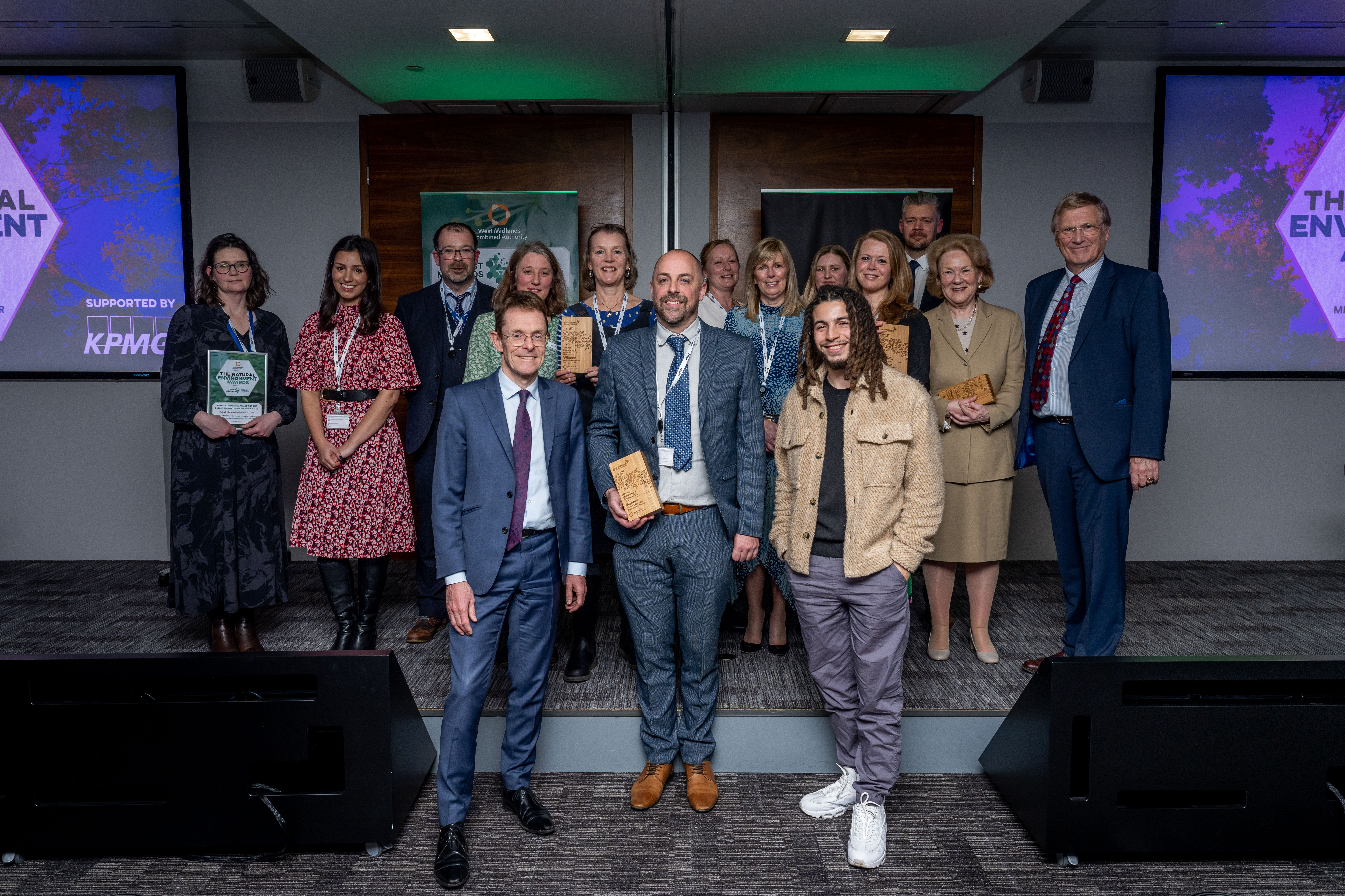 The Mayor of the West Midlands and the winners of the 2023 West Midlands Natural Environment Awards smiling at the camera holding their trophies.