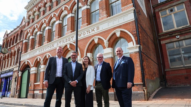 A group of 5 people standing outside Great Hampton Street works.